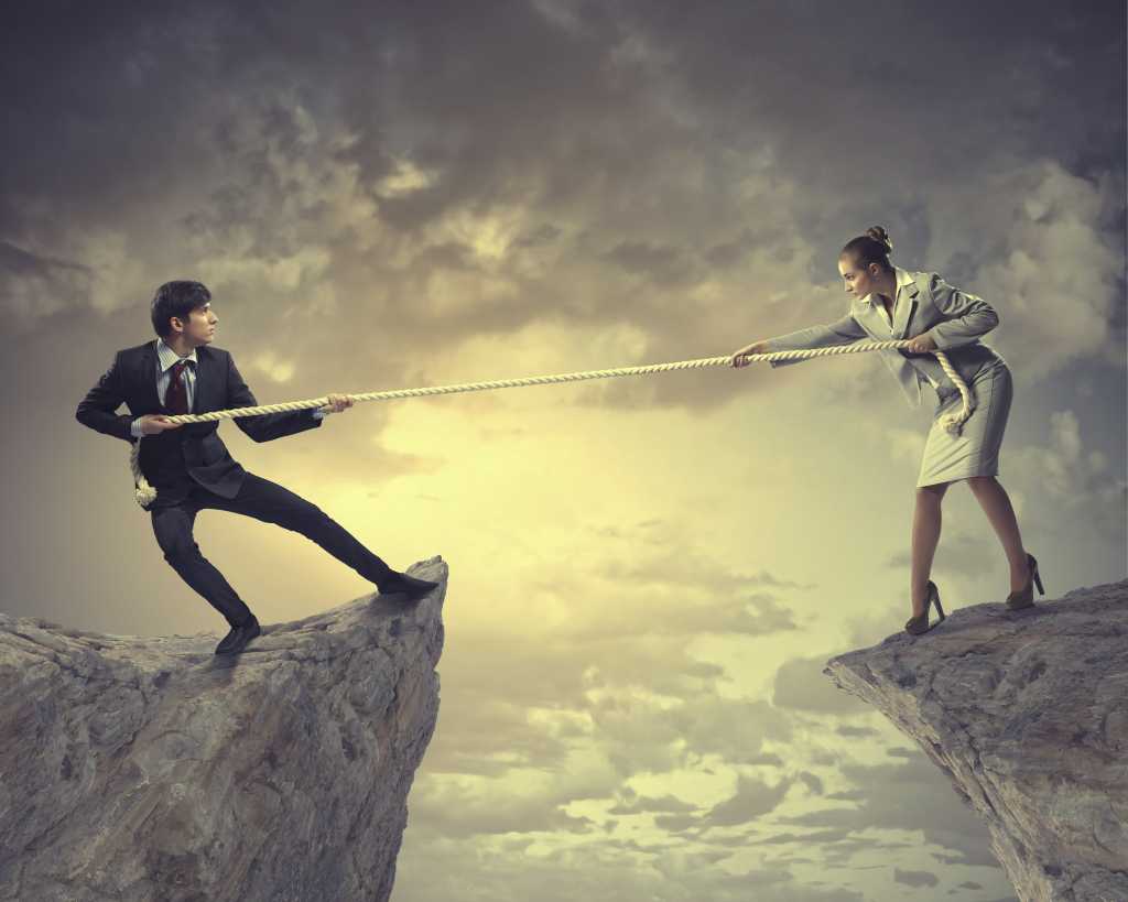 Business man woman pull rope tug of war cliff clouds struggle battle