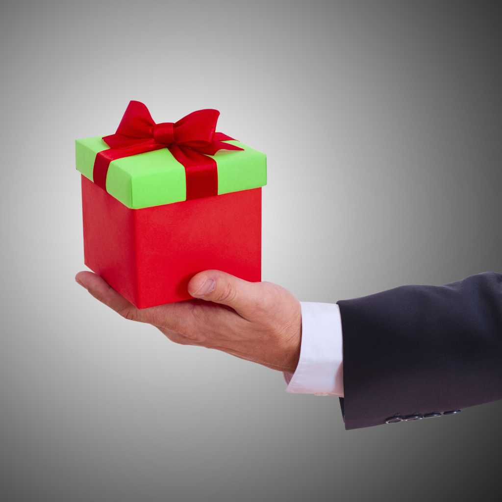 Businessman holding holiday gift box 187371991