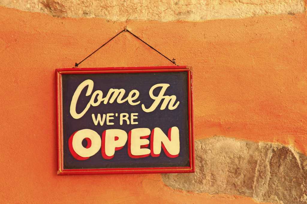 retro open for business sign on orange background