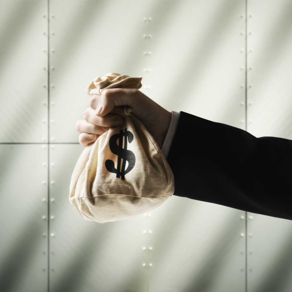 Businessman holding money bag 78775915