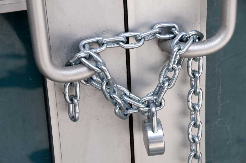 Locked chain on a door 87481768
