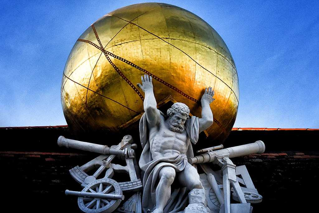 Statue of Atlas against a blue sky.