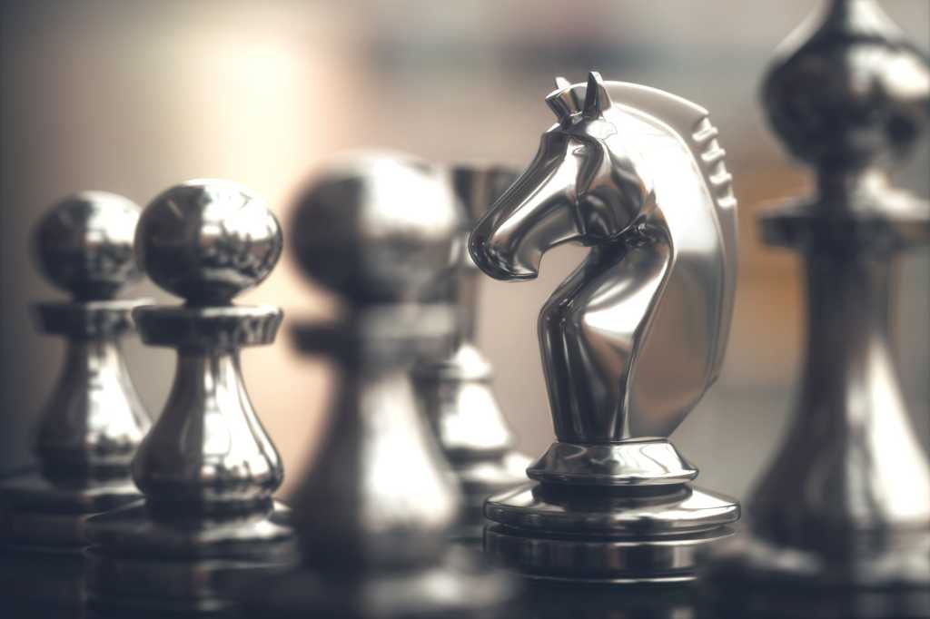 Chess pieces on a chessboard with the knight (horse) as focal point.