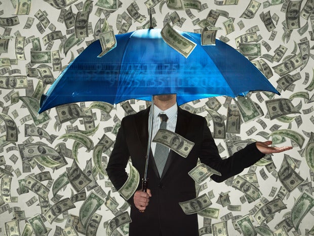 Man under umbrella raining money