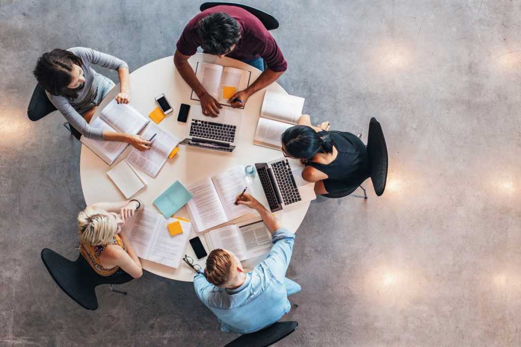 collaboration at a table with people and tools