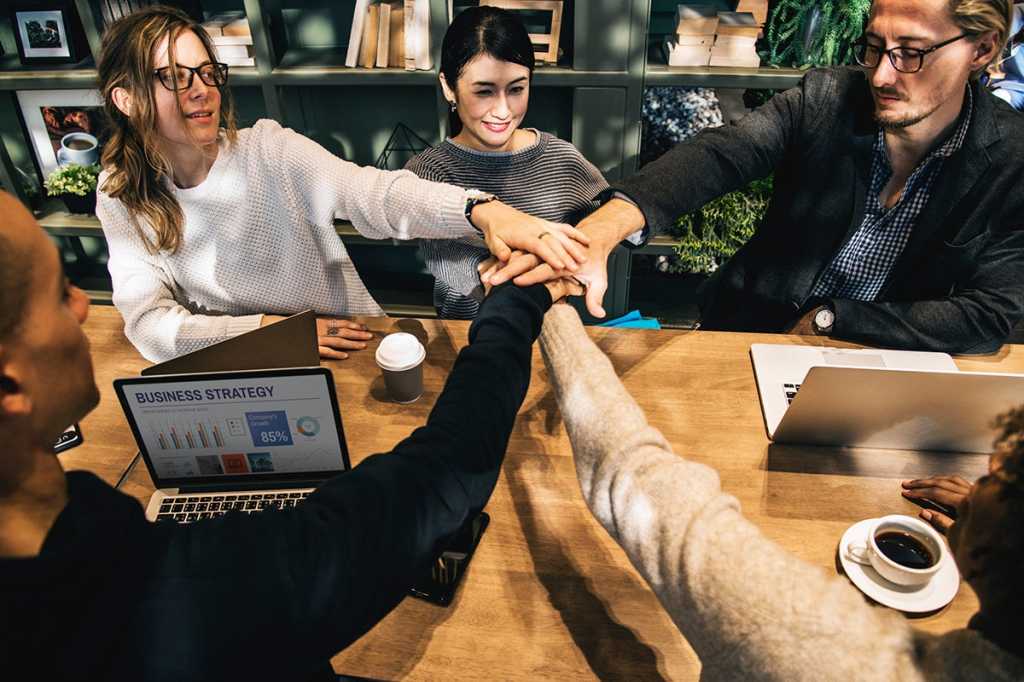 all hands in among a happy, collaborative group