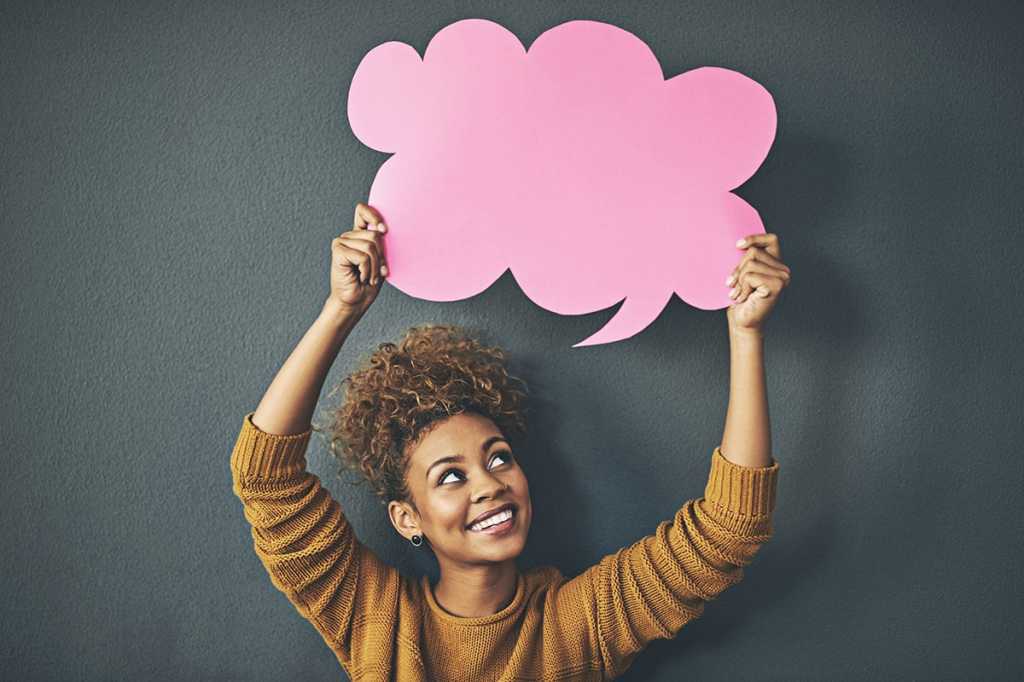 A woman holding a speech bubble.