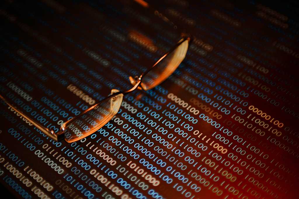 Eyeglasses rest on a binary field / code review / threat assessment / check vulnerabilities