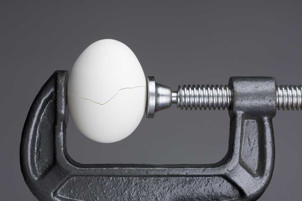 egg in vice under pressure stress