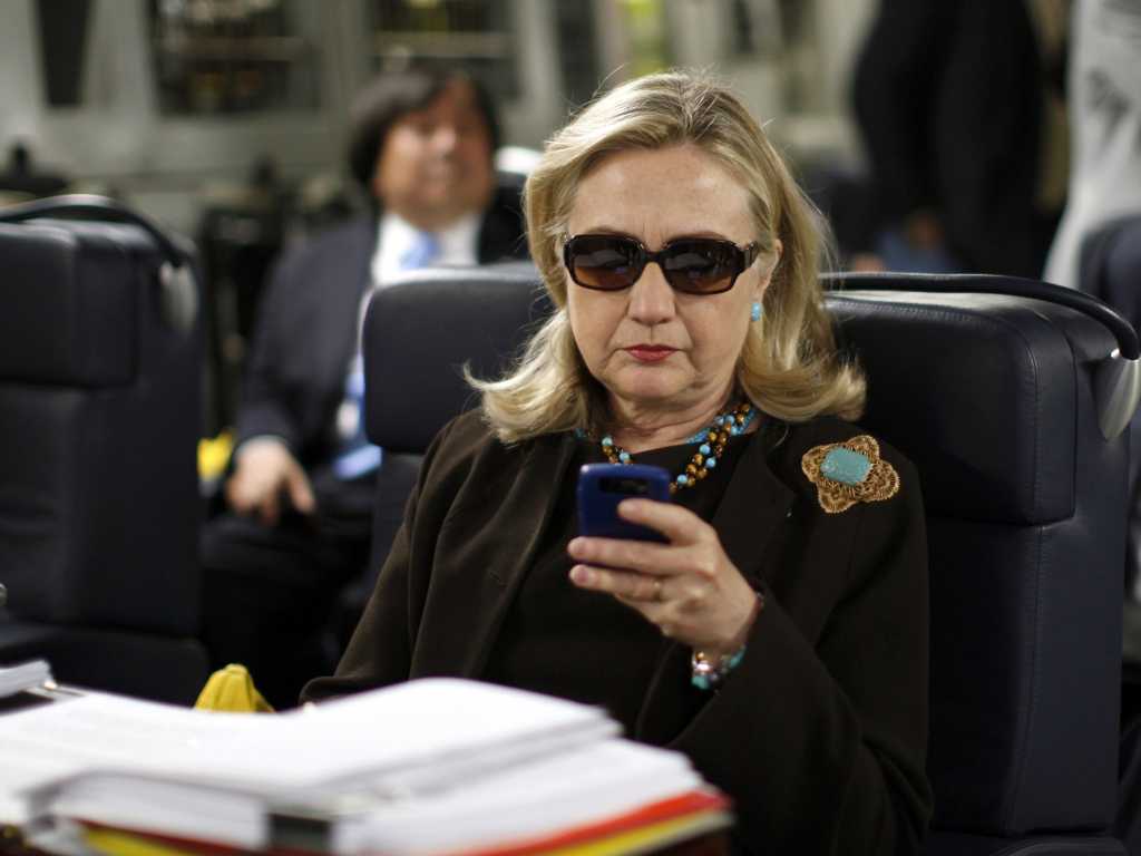 Hillary Clinton checking email on a BlackBerry