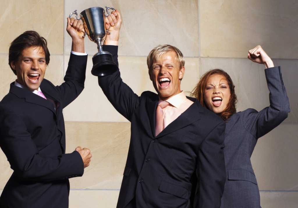 Group of executives holding trophy photo winners people men woman award