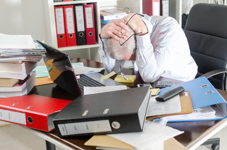 messy cio desk worker office frustration