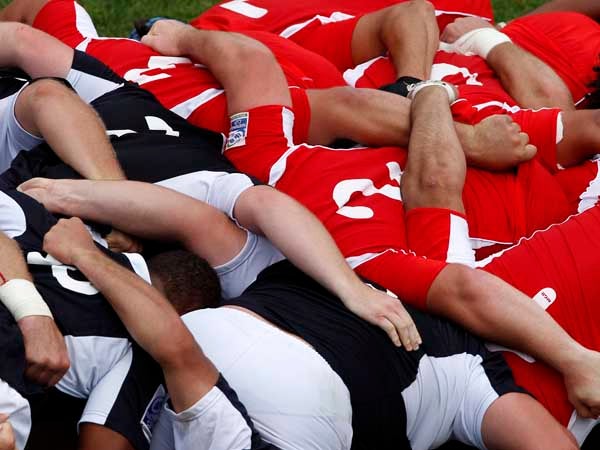 Georgia's players (R, red) and Namibia's players push each other in a scrum during their IRB Nations