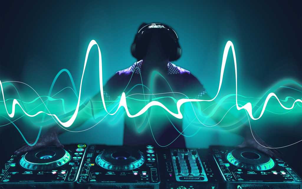 A DJ at the turntables - mixing, remix - Shutterstock
