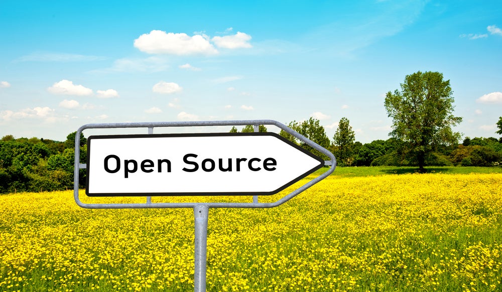 Open Source sign in yellow field against blue sky