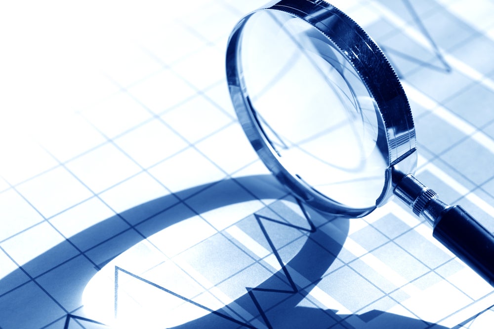 magnifying glass on business chart