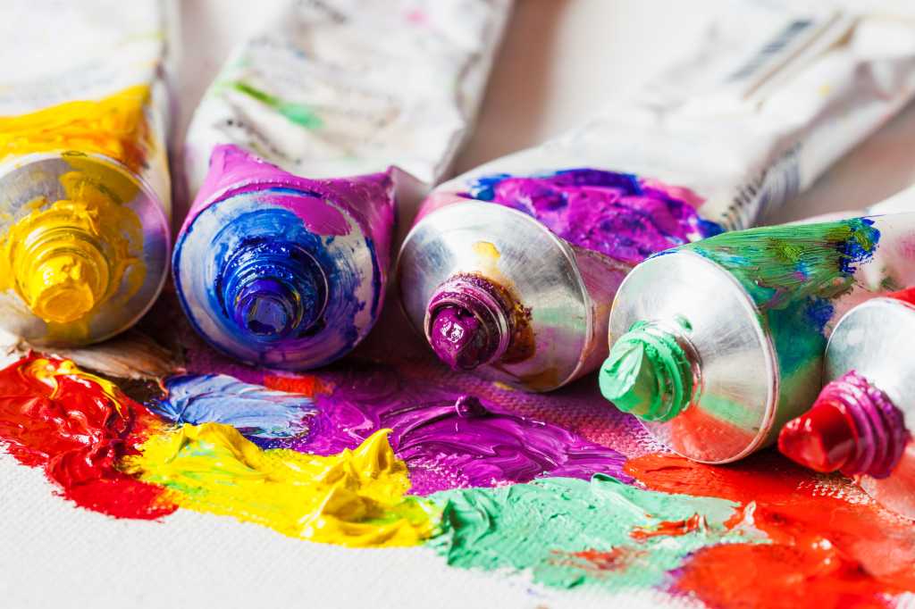 Tubes of oil paint closeup on artist palette with paints.