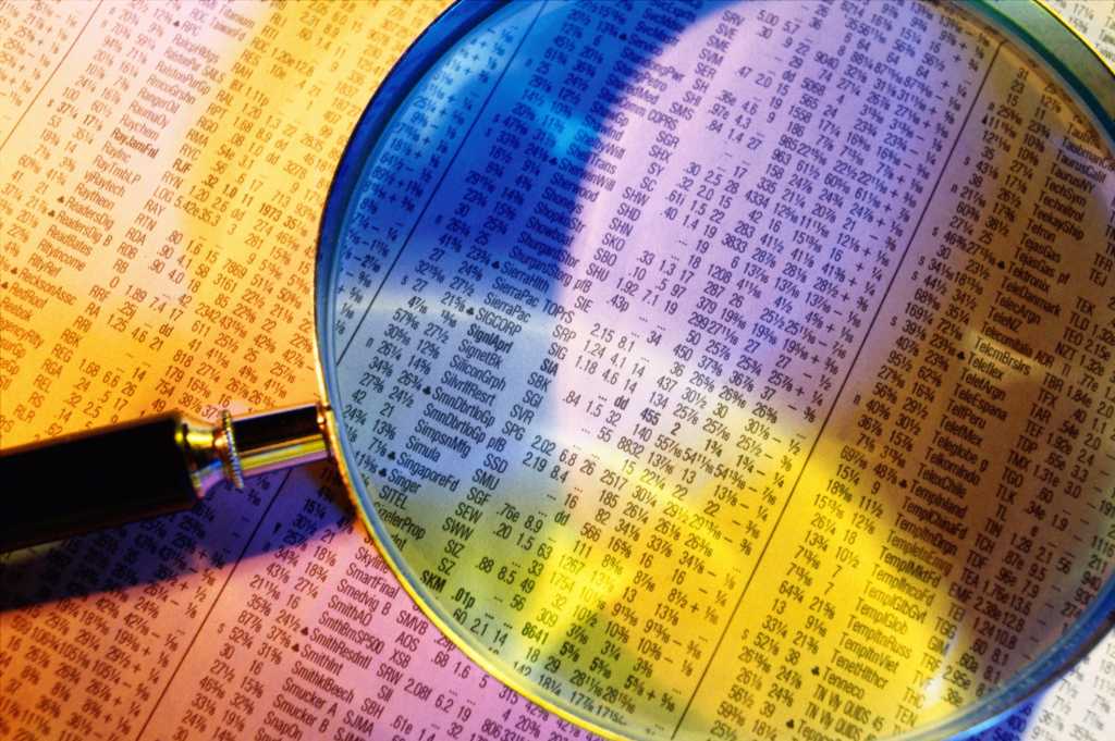 colorful financial report with magnifying glass