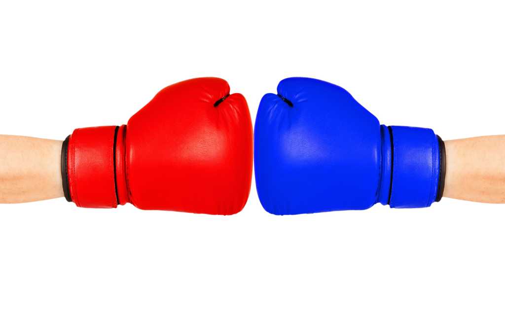 Red and blue boxing gloves facing each other