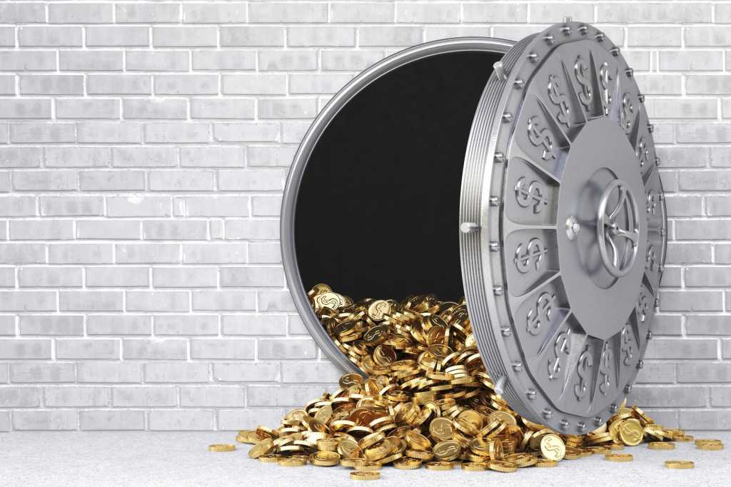 Open bank vault with gold coins spilling out
