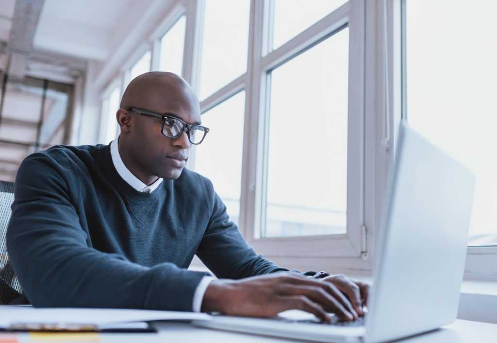 man sitting at laptop