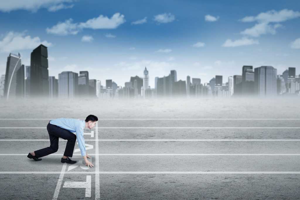 young businessman at starting line race run