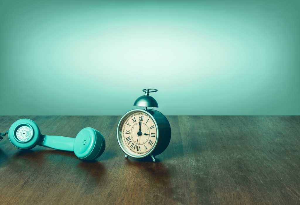 retro phone next to retro alarm clock