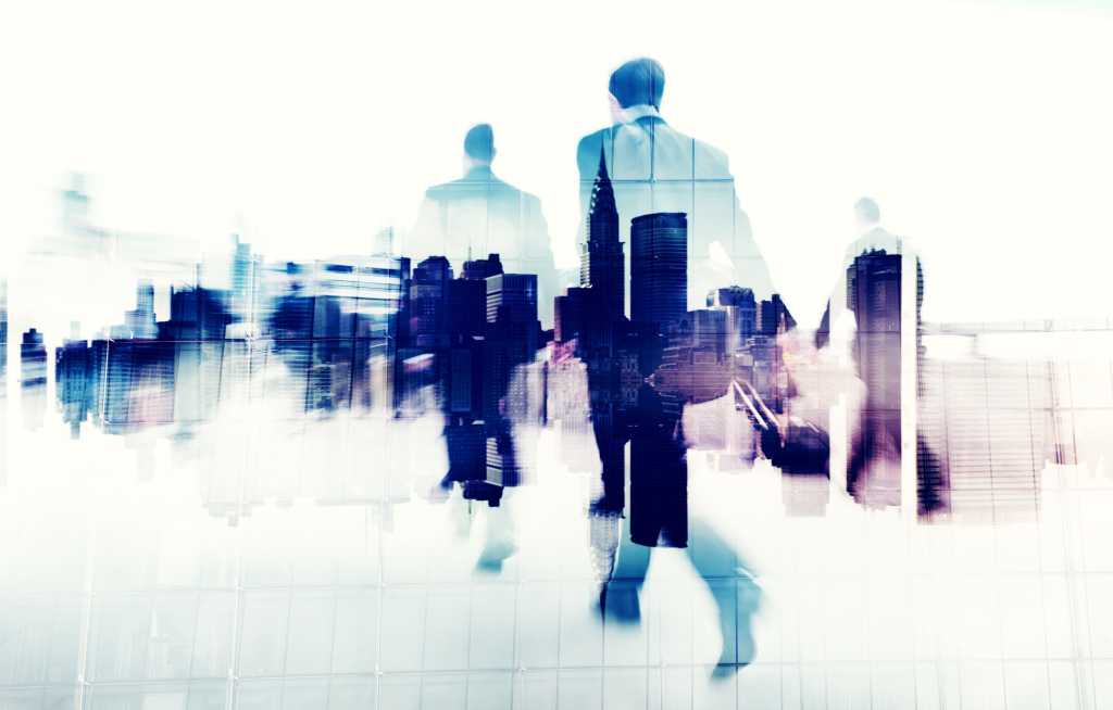 abstract image of executives walking with skyline superimposed on bodies