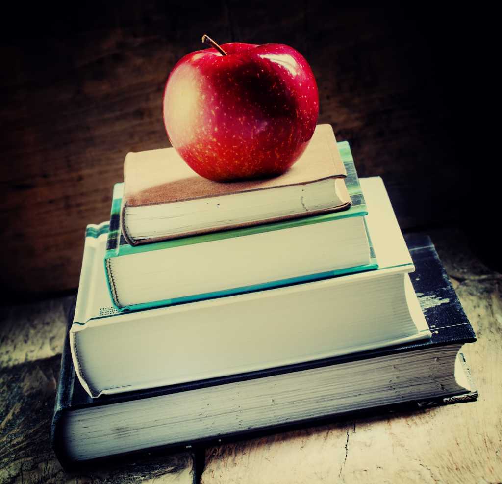 student books with apple for teacher