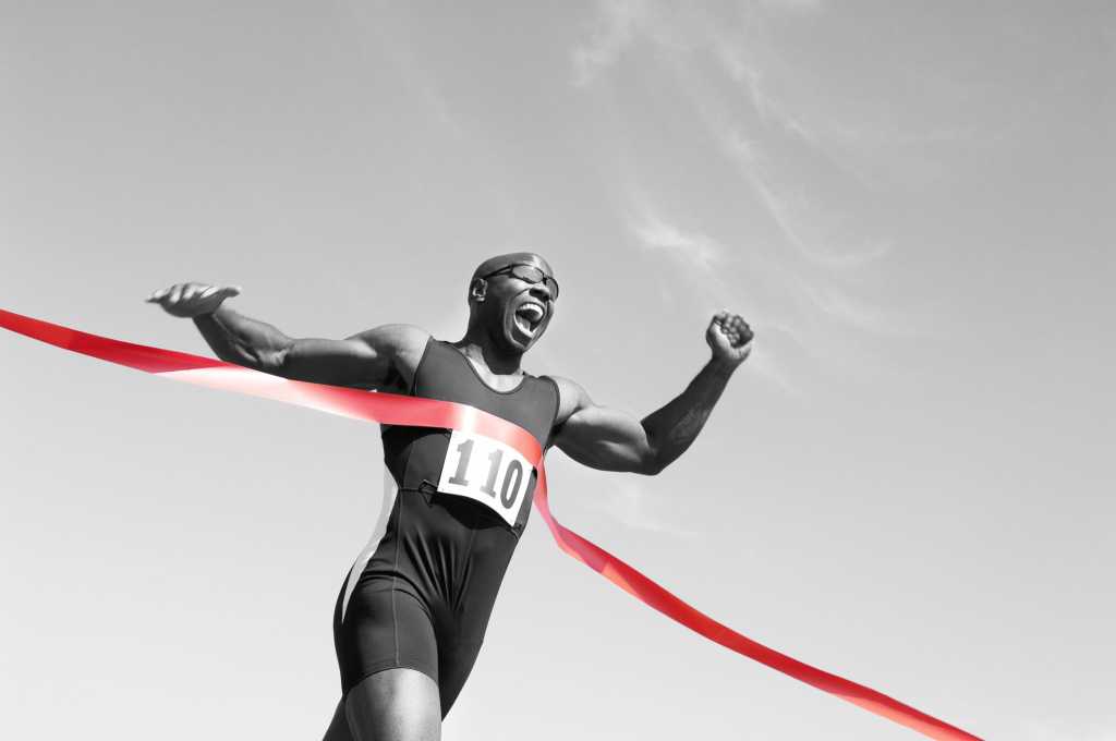 man running across finish line
