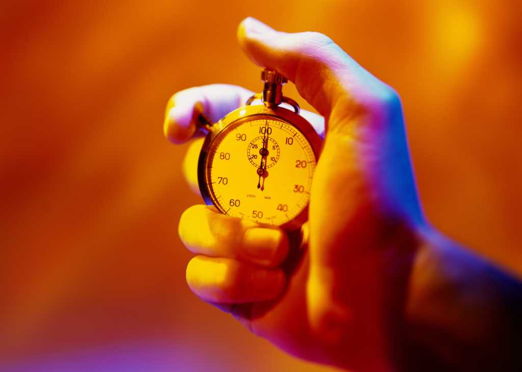 toned close up of a hand holding a stopwatch 57437132