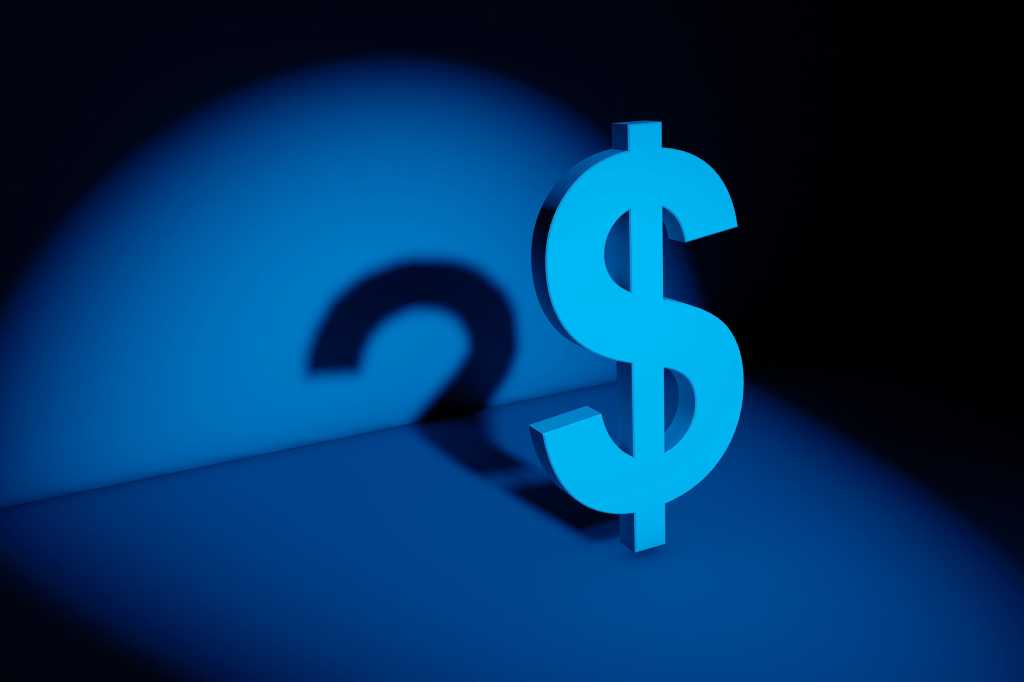A U.S. dollar sign casts a question mark shadow.