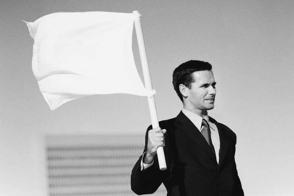 wave the white flag surrender give up quit