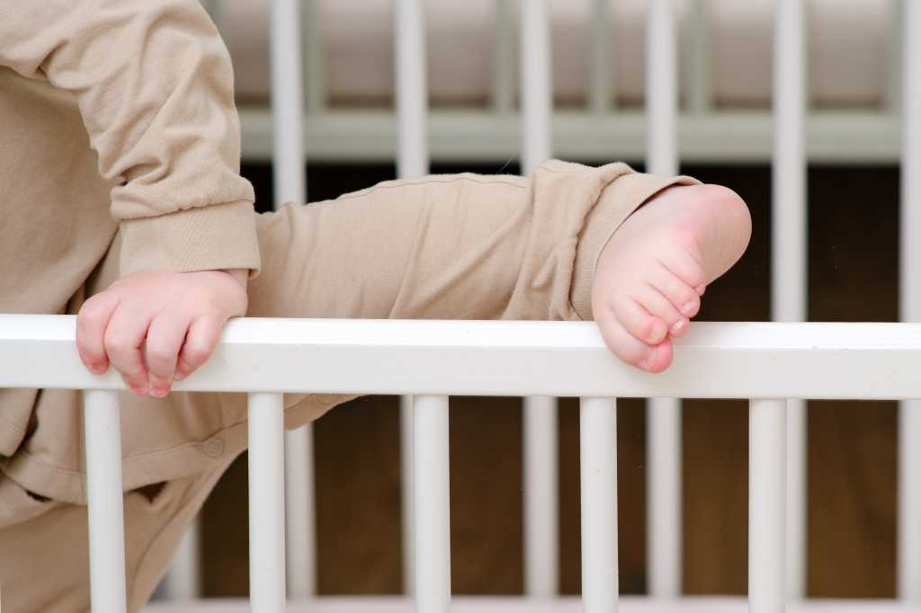 Child escapes from the crib by climbing over the railing.