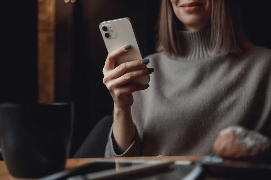 Young woman using iPhone