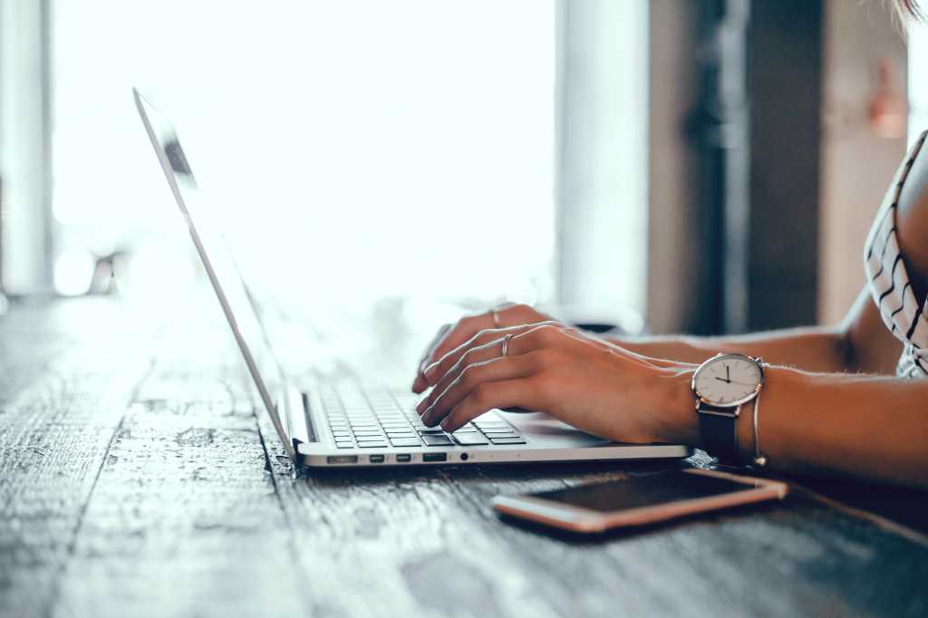 Woman using Mac laptop