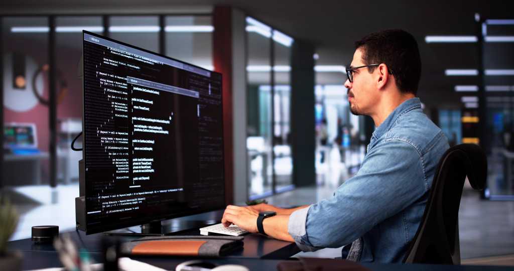 Web Developer Coding On Computer To Develop Code