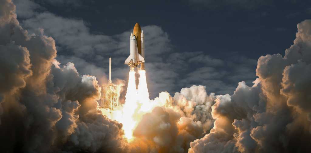 Spaceship, space age, liftoff: a space shuttle rises above the stratosphere.