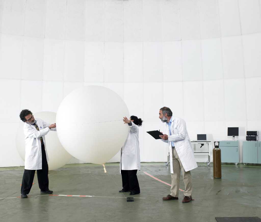 Research scientists examining balloon