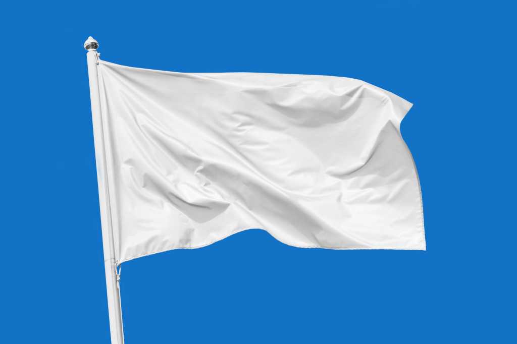 shutterstock 1629072523 white flag waving in the wind against a clear blue sky