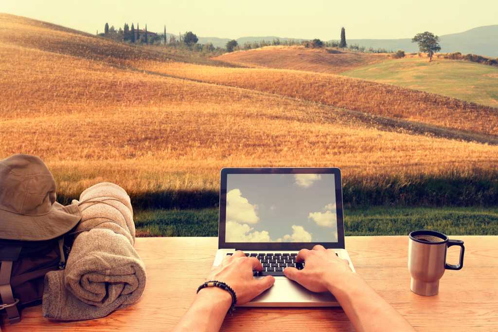 A laptop user in a remote, rural location benefits from wireless range and connectivity.