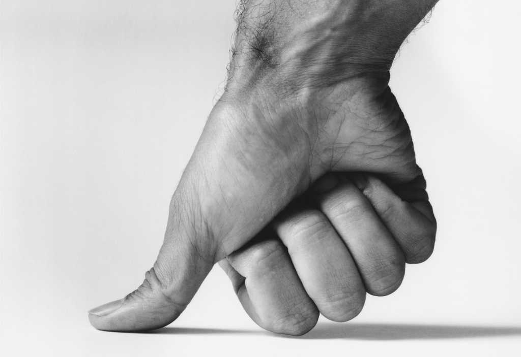 man's thumb showing power crushing ideas