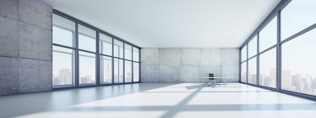 Empty office space in high-rise building with a view of the skyline