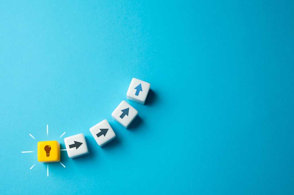 A lightbulb and arrow symbols trace the path from idea to implementation.