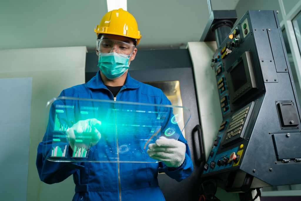 Person in construction hat and overalls using mobile agentic AI in field operations setting.