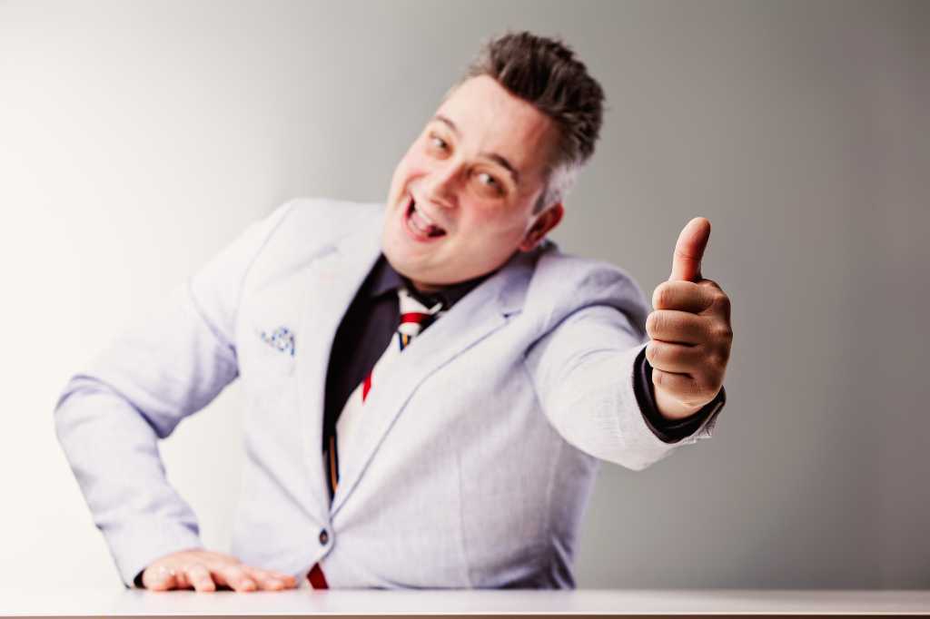 Salesman laughs deceptively with a thumbs up, warning of shady business practices