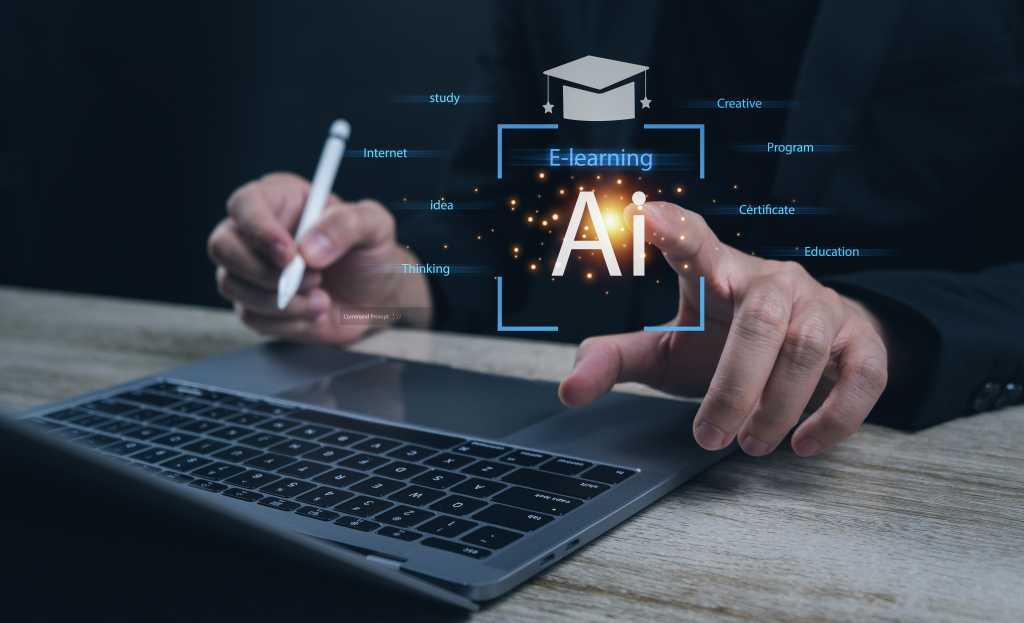 A person sits in front of a keyboard and virtual screen displaying the acronym "AI" and a stylized graduation cap.