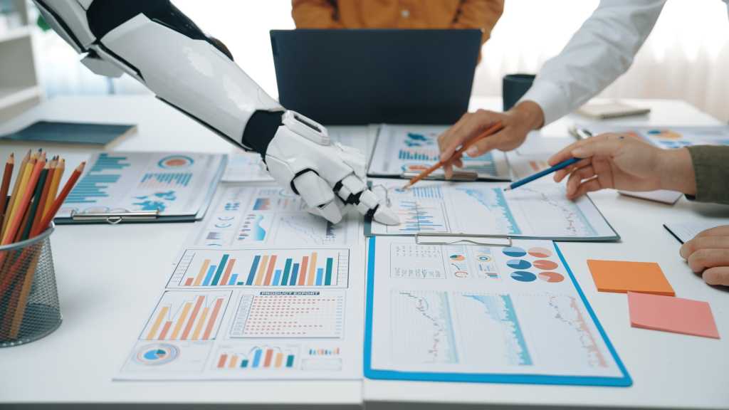 Human team collaborates with a robotic assistant on data analysis and strategy planning, showcasing the integration of technology in modern business environments.