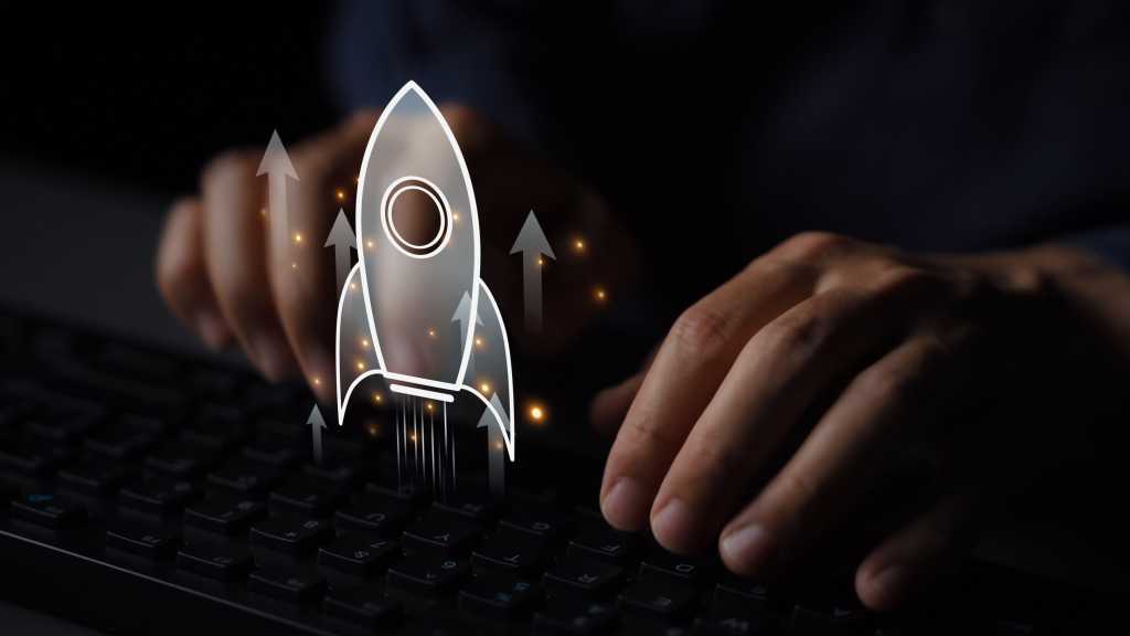 A person works at a keyboard with a virtual overlay of a rocket launch.
