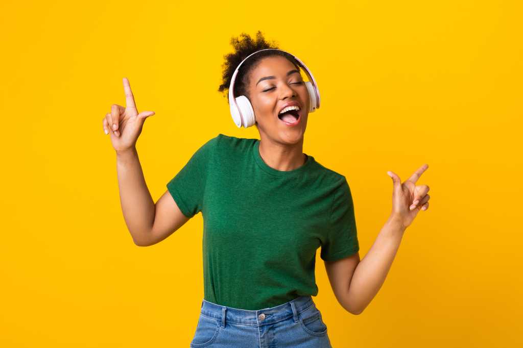 happy singing winning shutterstock 1761880700 young woman dancing